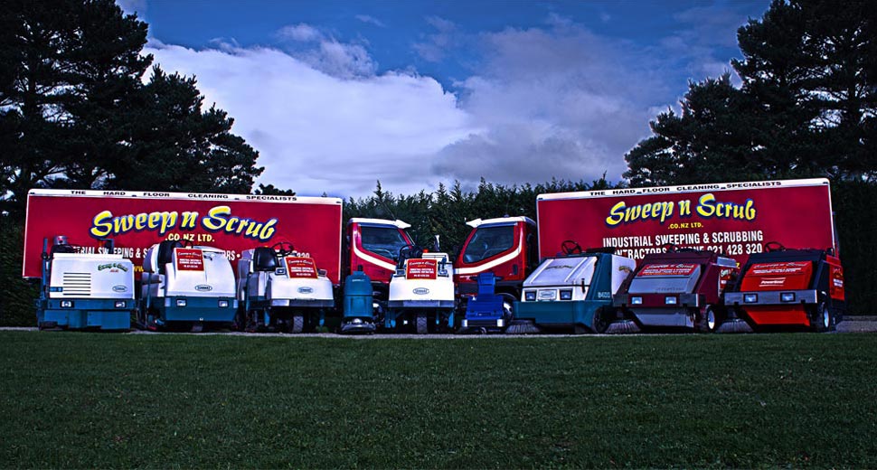 The Sweep n Scrub fleet: trucks, sweepers and scrubbers lined up on a lawn