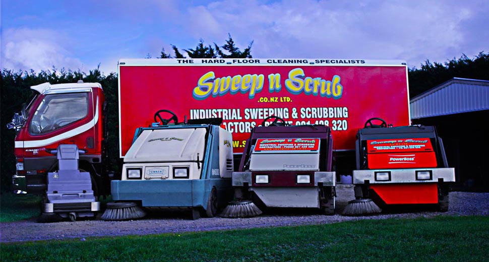 Ride-on sweepers in front of the Sweep n Scrub truck